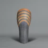 Ichino Masahiko A tall and sculptural ceramic vase, the upper section with stripes in blue, dark orange, and black enamel,